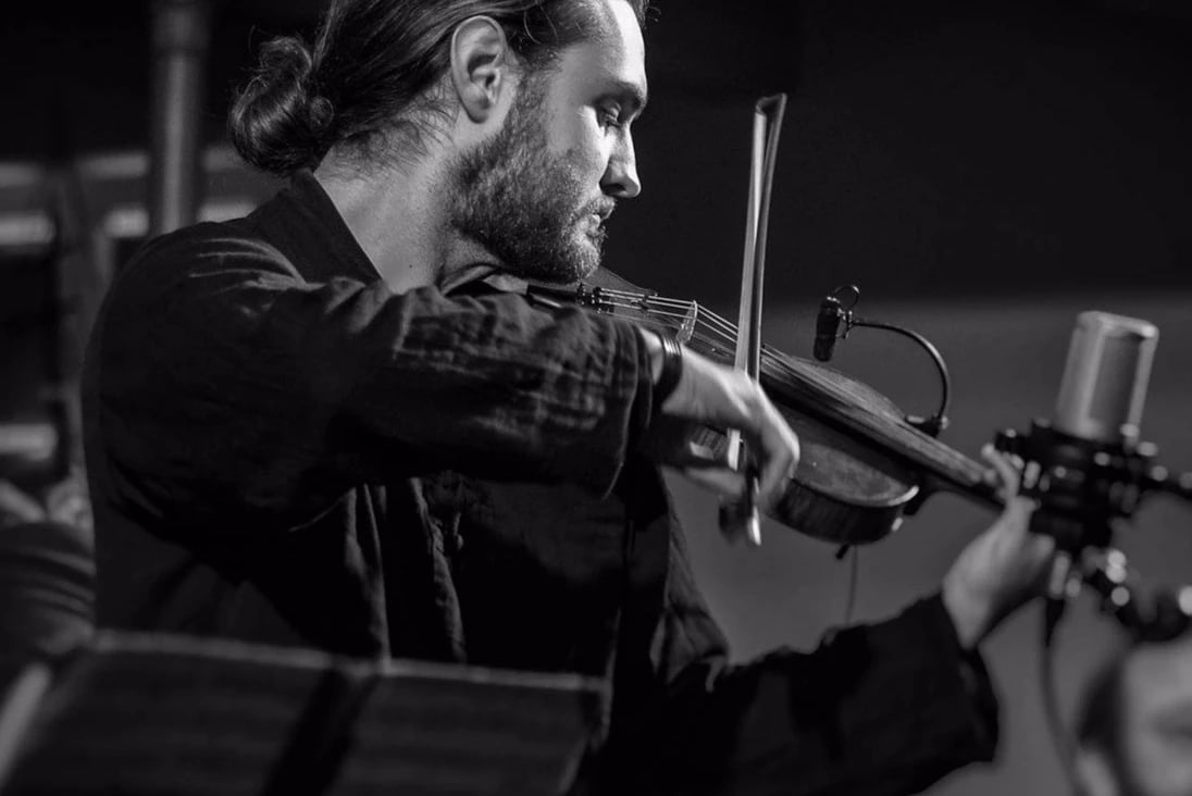 Violinist performing into a studio microphone